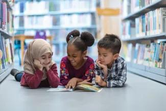 3 Students Reading a Book