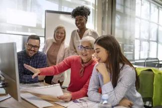 Group of staff working together on computer