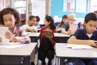 Teacher interacting with student in classroom setting